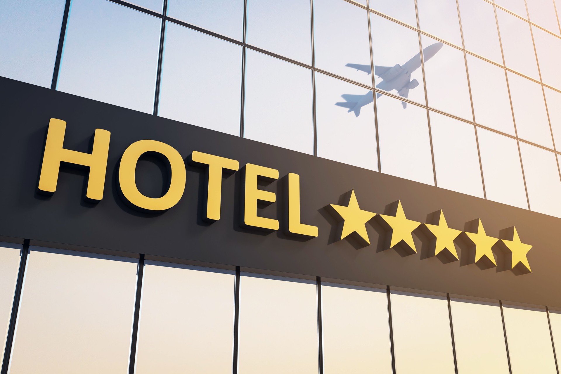 Modern five-star hotel signage with golden letters and stars on glass building exterior with airplane reflection in background at sunrise light. 3D Rendering