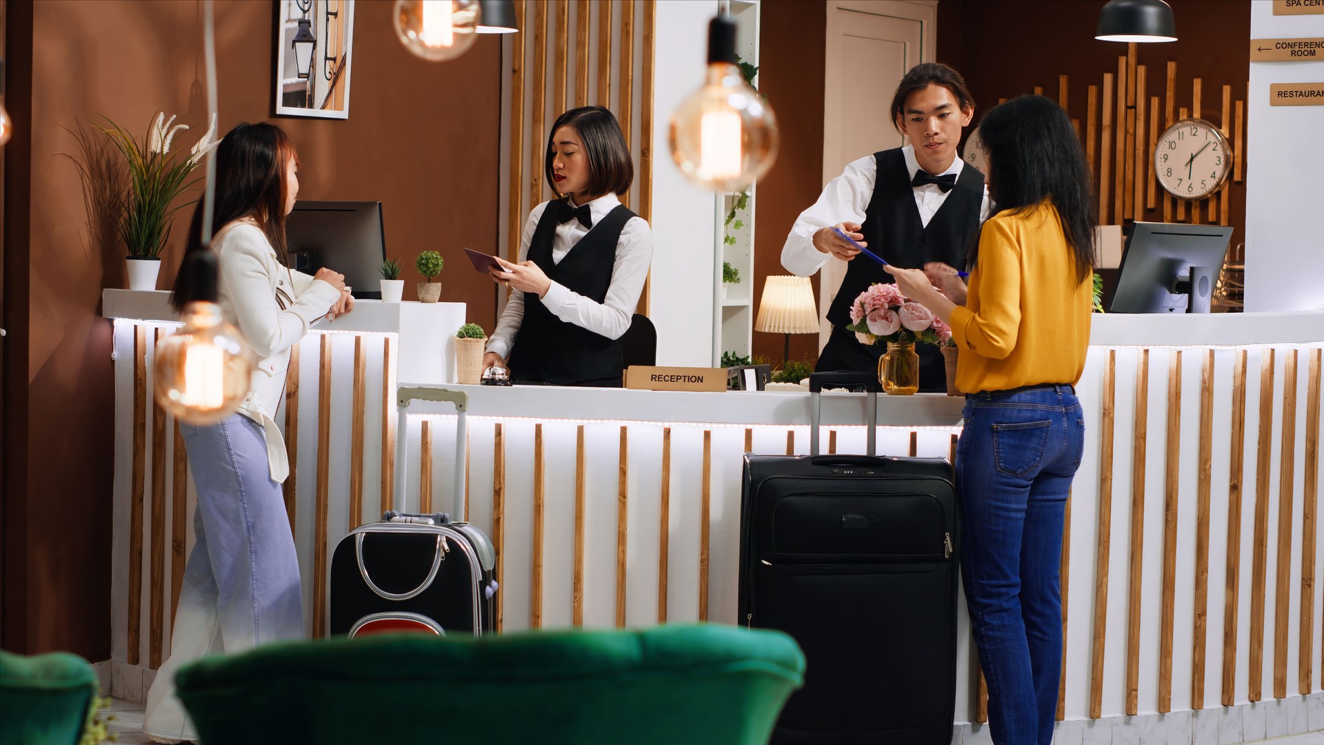 Women going through registration process at front desk